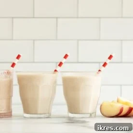 A creamy apple smoothie in a glass, perfect for a healthy snack.