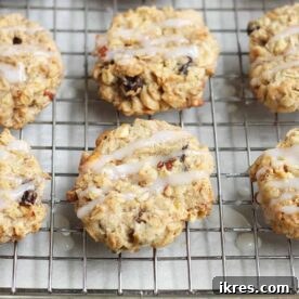 Apple cookies with icing cooling on a wire rack.