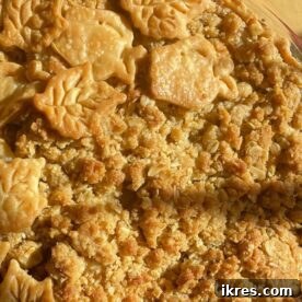 A beautiful Dutch Apple Pie decorated with cut-out pie crust leaves.