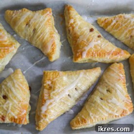 Easy make-ahead apple turnovers with flaky puff pastry and sweet icing.