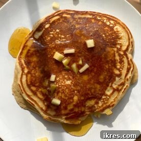 Paleo pancakes with diced apples and a sprinkle of apple pie spice.