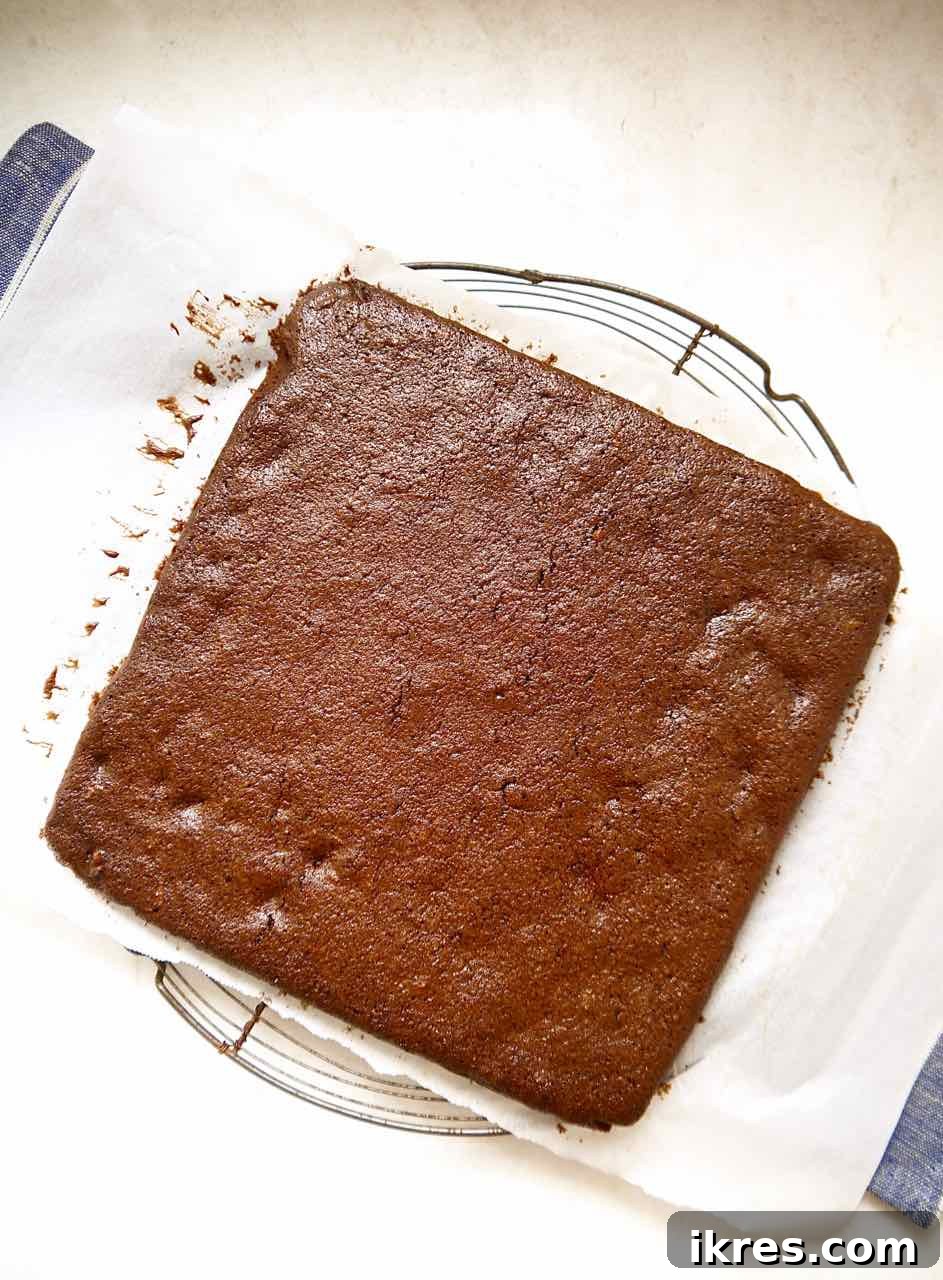 Gluten-Free Toasted Coconut Cloud Brownies 6 Freshly baked coconut and chocolate brownies cooling on a wire rack.