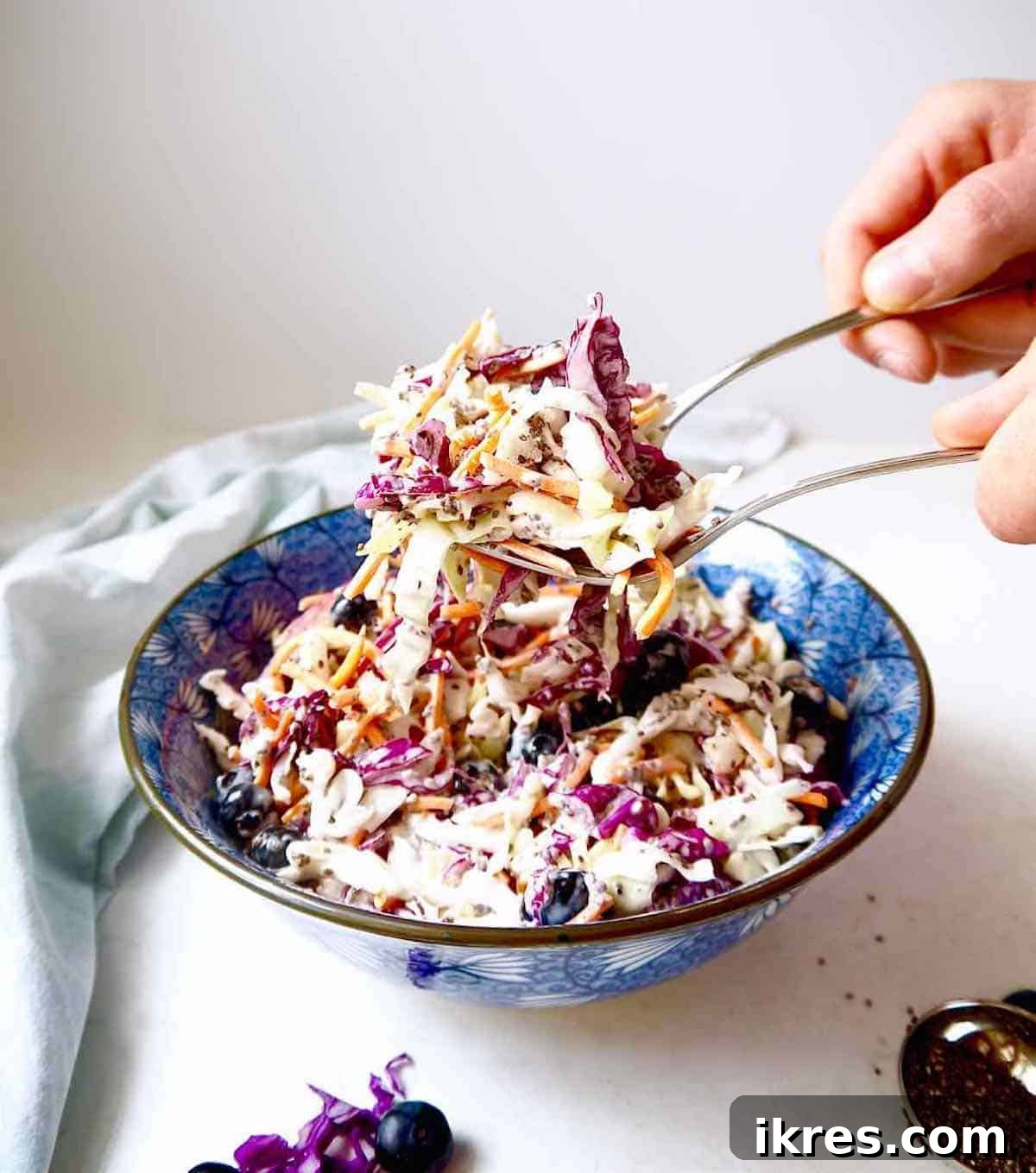Paleo Berry Chia Slaw: A Dairy-Free Superfood Twist 8 Light coleslaw recipe being served with silverware.