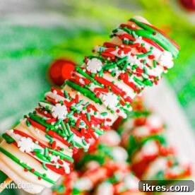 Festive Christmas Marshmallow Pops dipped in chocolate and decorated with sprinkles, a simple and sweet holiday treat.