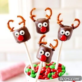 Cute Chocolate Covered Marshmallow Reindeer with pretzel antlers and candy eyes, a fun Christmas treat.