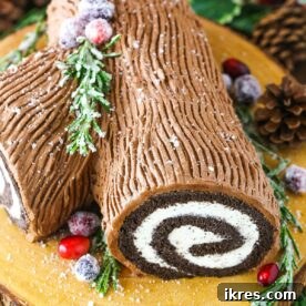 Chocolate Yule Log Cake (Bûche de Noël) decorated to resemble a festive tree log, a classic holiday dessert.