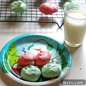 Christmas Meringue Cookies piped into festive shapes, a light and airy holiday dessert.