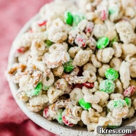 Christmas Reindeer Chow with white chocolate, pretzels, Chex cereal, and M&M's, a delicious holiday snack mix.