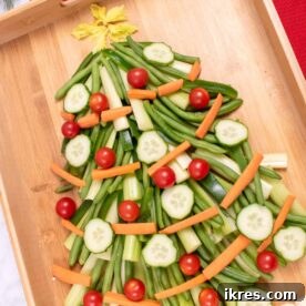 Vegetable Christmas Tree Appetizer Tray made with broccoli, cherry tomatoes, and bell peppers, a healthy holiday snack.