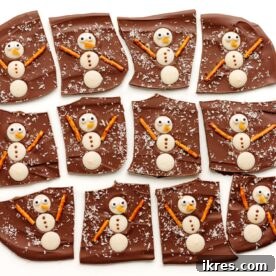 Snowman Christmas Bark made with white chocolate and decorated with festive candies, a simple no-bake holiday treat.