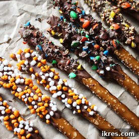 Chocolate Covered Pretzel Rods decorated with sprinkles, a delightful sweet and salty holiday treat.