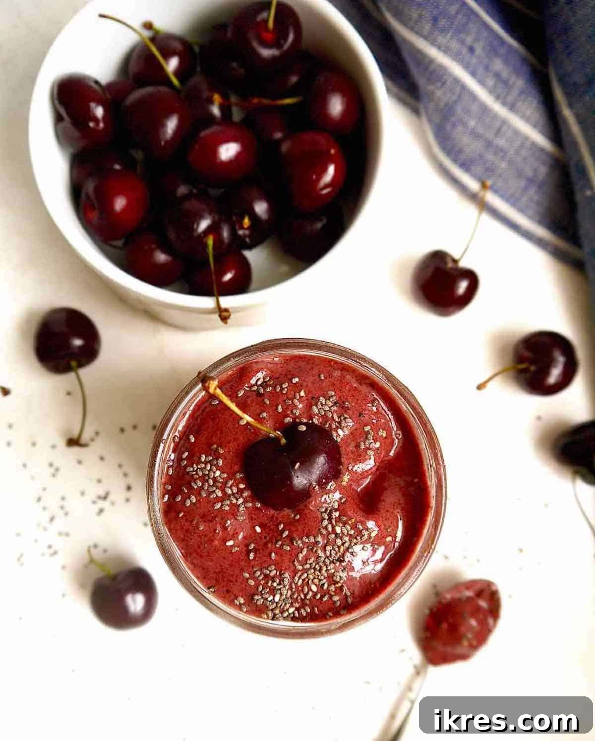 Velvet Chocolate Cherry Banana Delight 5 Cherry banana smoothie in a jar with a bowl of cherries next to it.