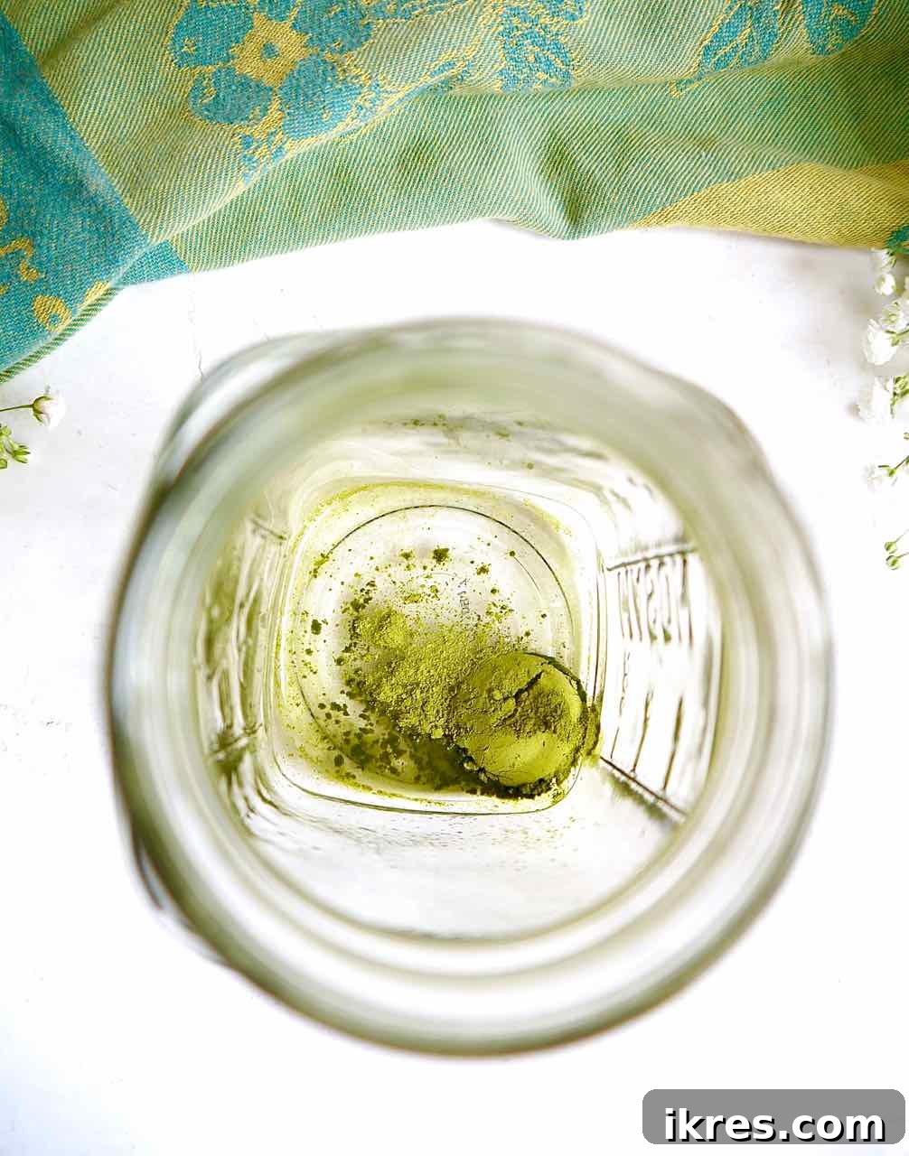 Creamy Vegan Iced Almond Matcha Latte 6 Matcha powder settled at the bottom of a mason jar.