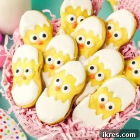 The cutest hatching chick Easter treats made out of Nutter Butters, dipped in yellow candy melts and decorated with edible eyes and beaks, appearing simple, adorable, and fun to eat.