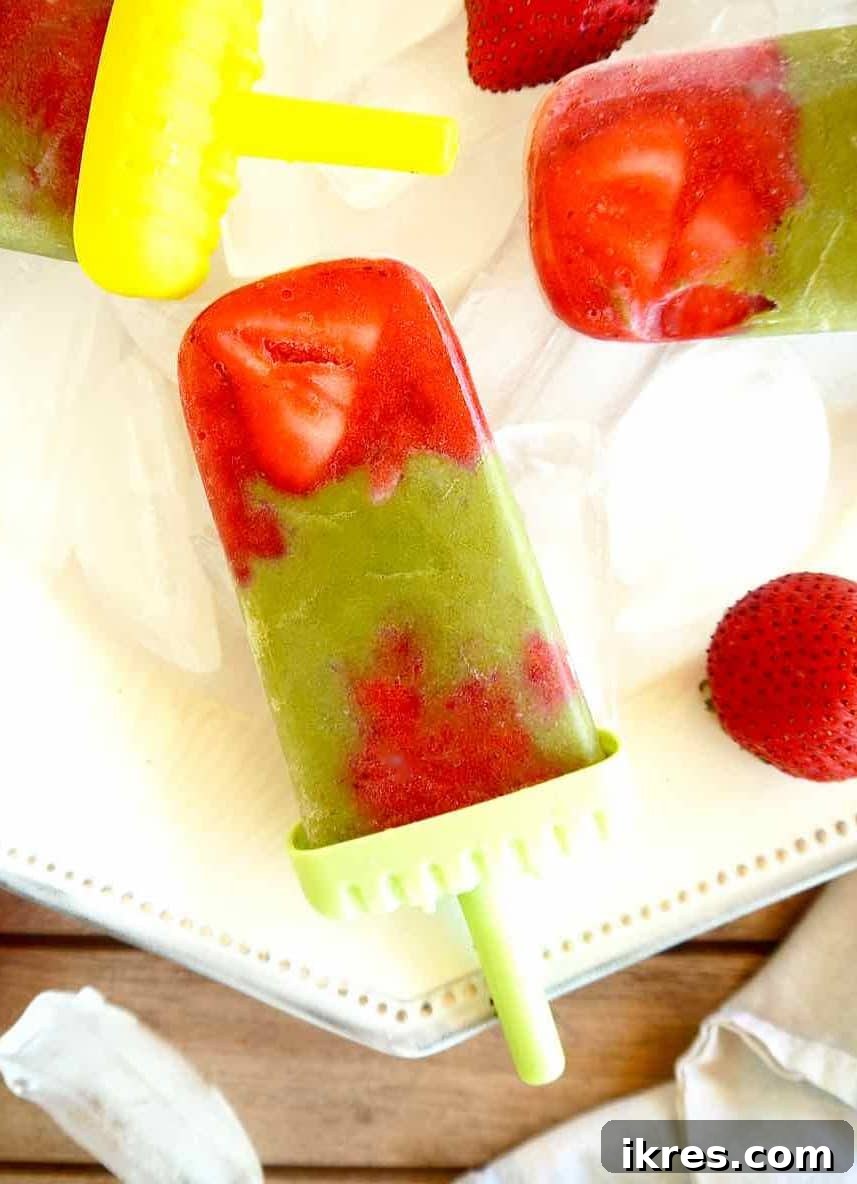 Strawberry Matcha Fusion Pops 3 A close-up of a Strawberry Matcha Popsicle showing the beautiful layered pattern, ready to be eaten.