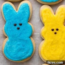 Buttery soft and tender Easter Bunny Cut Out Sugar Cookies with a slightly crisp outside, topped with marshmallow buttercream frosting and sparkling sugar, perfect for Easter.
