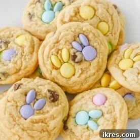 Easter Cookies packed with pastel M&M’s and chocolate chips, creatively topped with more M&M’s arranged into a bunny shape, presented as a delightful holiday treat.