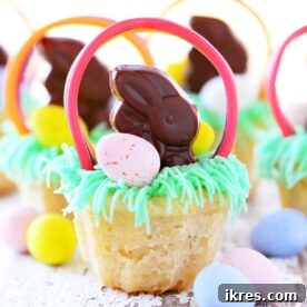 Adorable Easter Basket Cookie Cups, filled with buttercream frosting, mini chocolate bunnies, and candy eggs, described as almost too fun to eat.