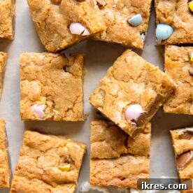 Mini Egg Easter Blondies, an easy dessert to make this spring, featuring chocolate Cadbury mini eggs stirred in for an Easter surprise.