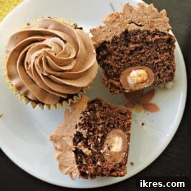 Cadbury Creme Egg Cupcakes, featuring a moist chocolate sponge, a hidden mini Cadbury Creme Egg, and smooth chocolate buttercream, presented as a delectable Easter treat.