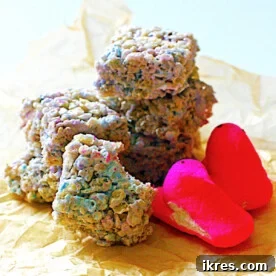 A colorful pile of Rice Krispies treats, each made with marshmallow Peeps, showcasing vibrant pastel hues and a delightful texture, perfect for an Easter celebration.
