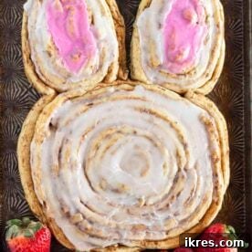 A large Bunny Cinnamon Roll crafted from refrigerated cinnamon rolls, presented as the perfect and super easy recipe for an Easter breakfast.