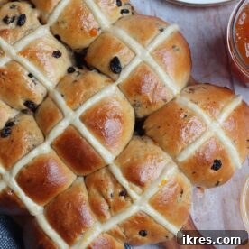 Hot Cross Buns, lightly spiced and easy to make, presented as the perfect Easter treat, delicious hot or cold with a brush of butter.