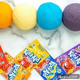 Homemade Kool Aid Playdough, shown with vibrant colors, an easy and fun craft idea for kids that is both edible and non-toxic.