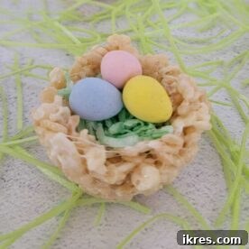 Easter Rice Krispie Nests adorned with colorful Cadbury Mini Eggs, showcasing a quick and easy no-bake dessert recipe that is both delicious and festive for spring celebrations.