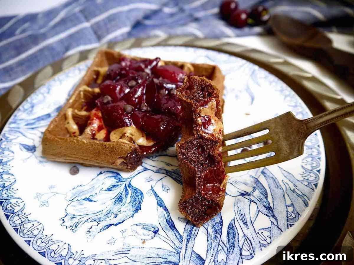 Decadent Grain-Free Chocolate Cherry Waffles 7 A bite of a chocolate cherry waffle on a fork.
