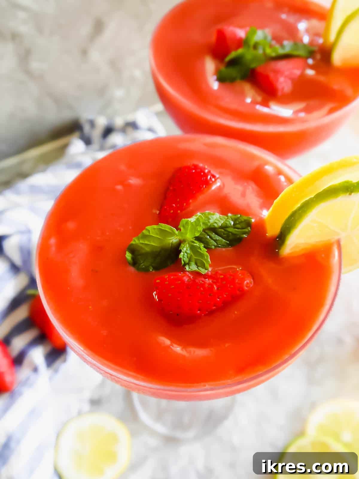 A beautiful healthy daiquiri made with strawberries in in two glasses, ready to be served.