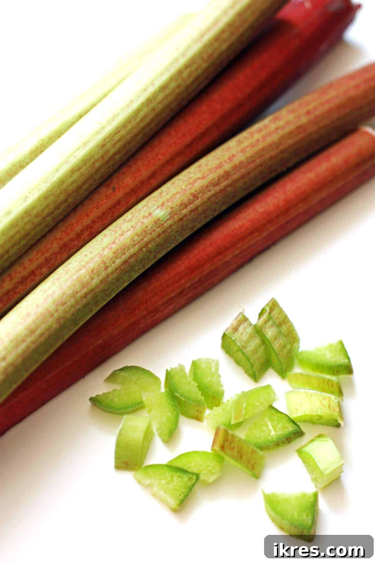 The Ultimate 20 Rhubarb Recipes for Your Spring Kitchen 2 A pile of fresh rhubarb and some perfectly cut slices, illustrating how to prepare it for strawberry rhubarb crumble bars.