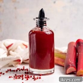 A bottle of homemade Rhubarb Syrup, perfect for cocktails and desserts.