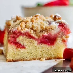 Strawberry Rhubarb Bars with a rich vanilla cake base and crumb topping.