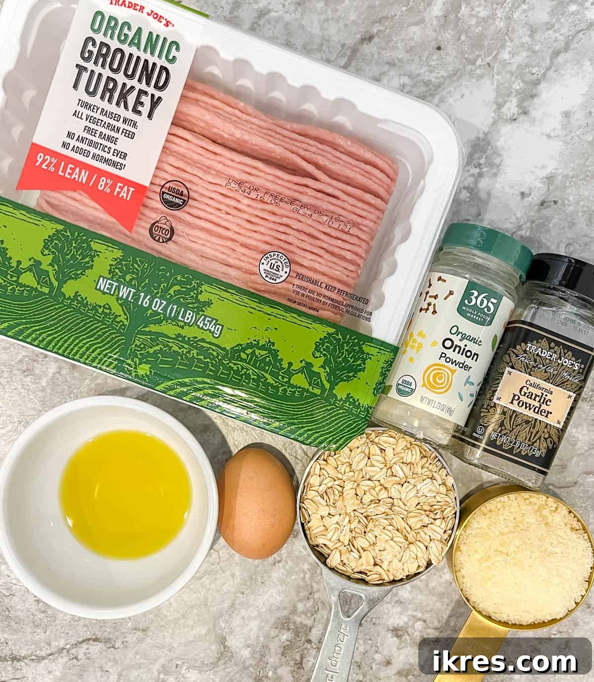 Various fresh ingredients for gluten-free turkey meatballs laid out on a kitchen counter.