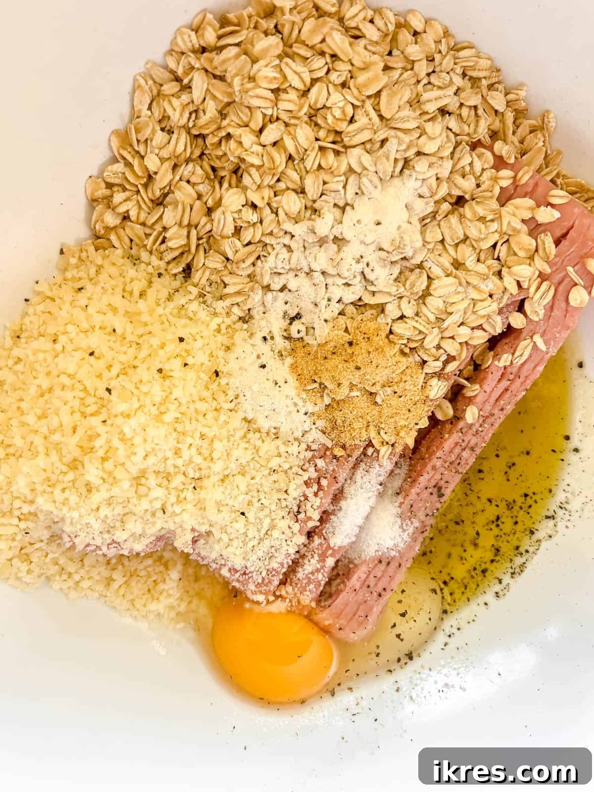 All the raw ingredients for gluten-free turkey meatballs mixed thoroughly in a large bowl.