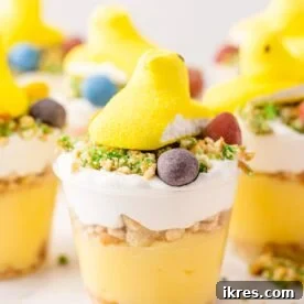 Close-up of an Adorable Peeps Easter Pudding Cup, layered with pudding and cookie crumbs, topped with a colorful Peep.
