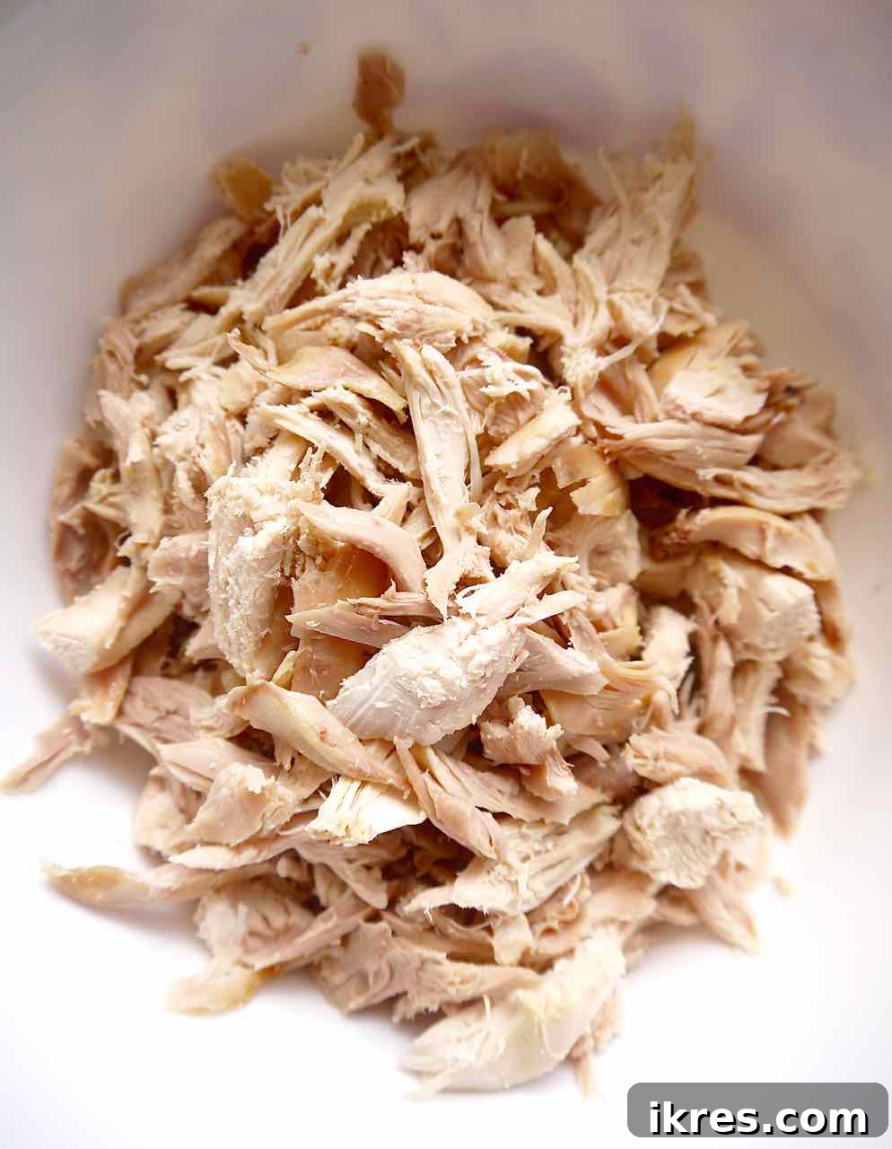 Speedy Rotisserie Chicken Salad Lettuce Cups 4 Rotisserie chicken meat in small pieces in a bowl, ready for mixing.
