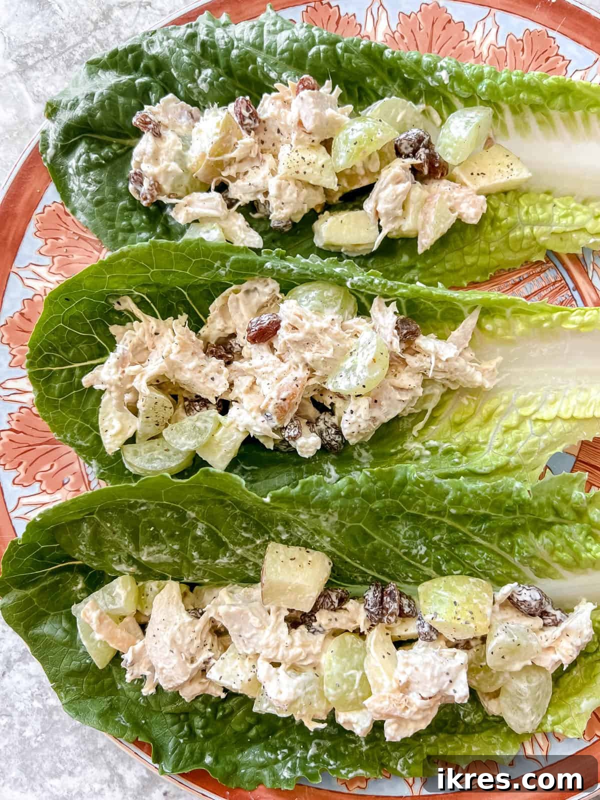 Speedy Rotisserie Chicken Salad Lettuce Cups 8 Rotisserie chicken salad beautifully arranged on fresh lettuce wraps on a plate, ready to be served.