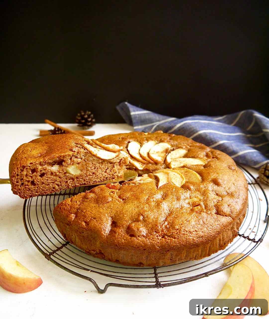 Wholesome Grain-Free Apple Cake with Almond Flour 7 Paleo apple cake on a cooling rack after baking, showing a golden-brown top.