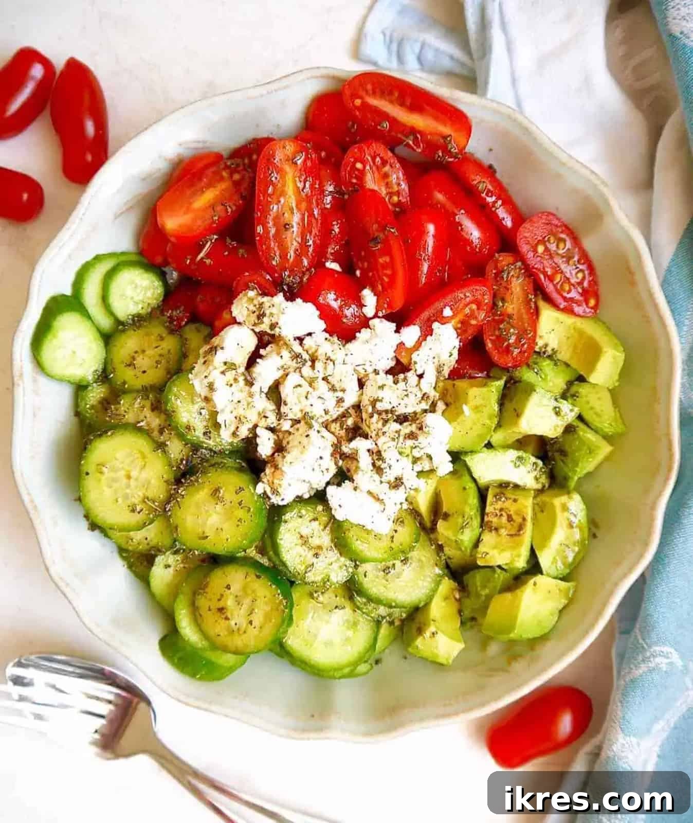 Vibrant Avocado Goat Cheese Salad with Balsamic Drizzle 2 Vibrant Cucumber Tomato Avocado Salad with Goat Cheese and Balsamic Dressing in a serving bowl.