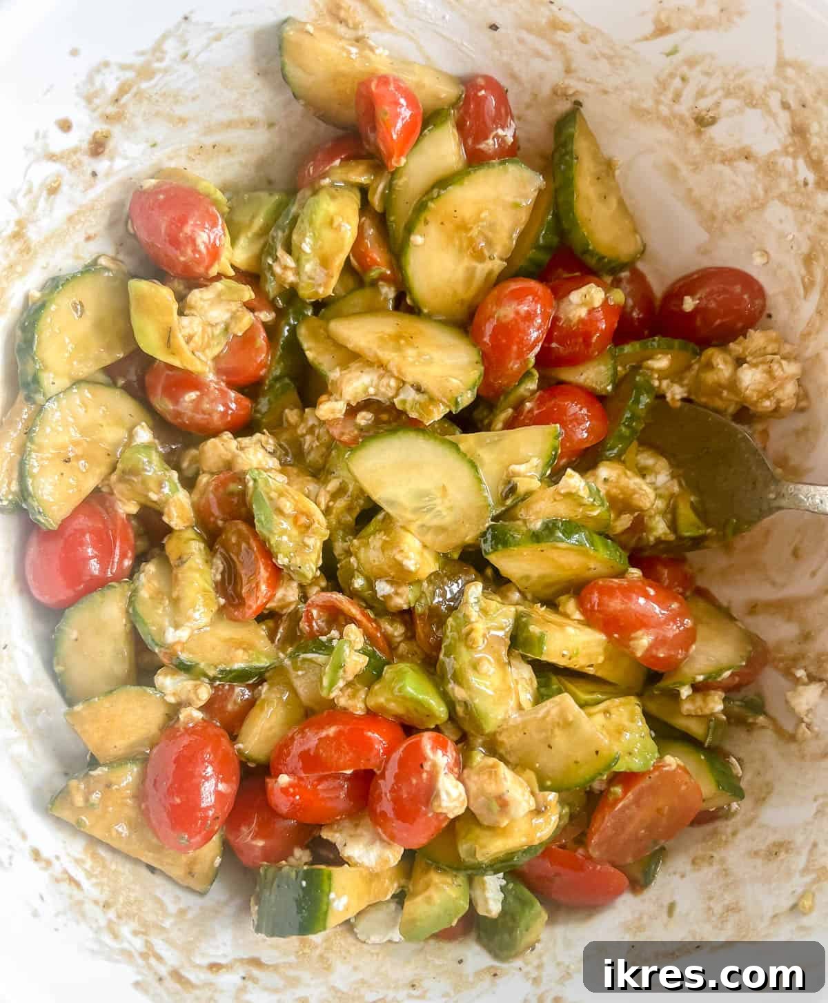 Vibrant Avocado Goat Cheese Salad with Balsamic Drizzle 6 Cucumber tomato and avocado salad mixed together with goat cheese.