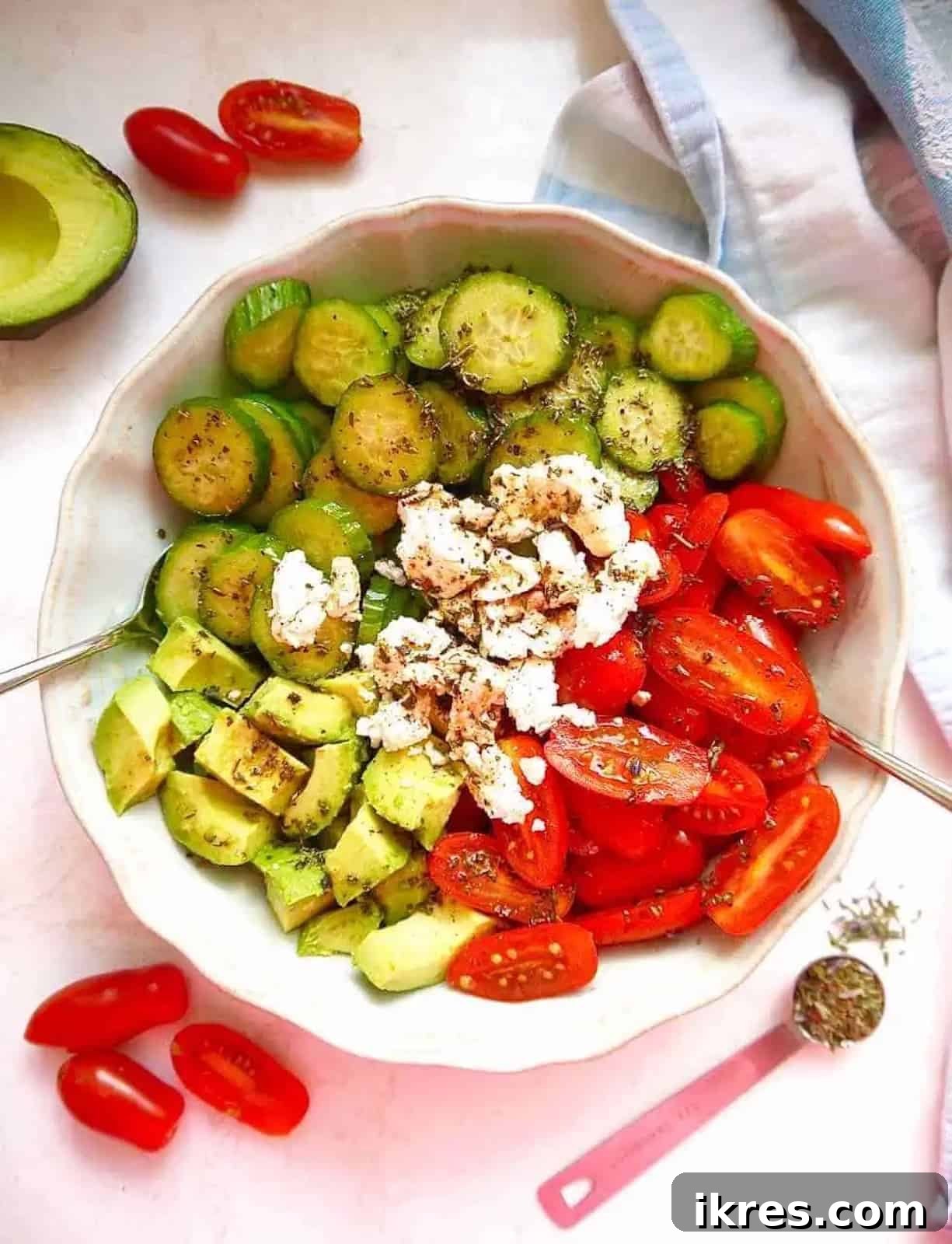 Vibrant Avocado Goat Cheese Salad with Balsamic Drizzle 7 Cucumber goat cheese salad with avocado and tomatoes in a bowl, ready to serve.