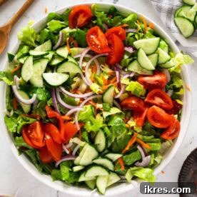 A simple house salad with fresh greens and chopped vegetables.