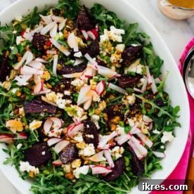 Roasted beet salad with goat cheese, pistachios, and arugula.