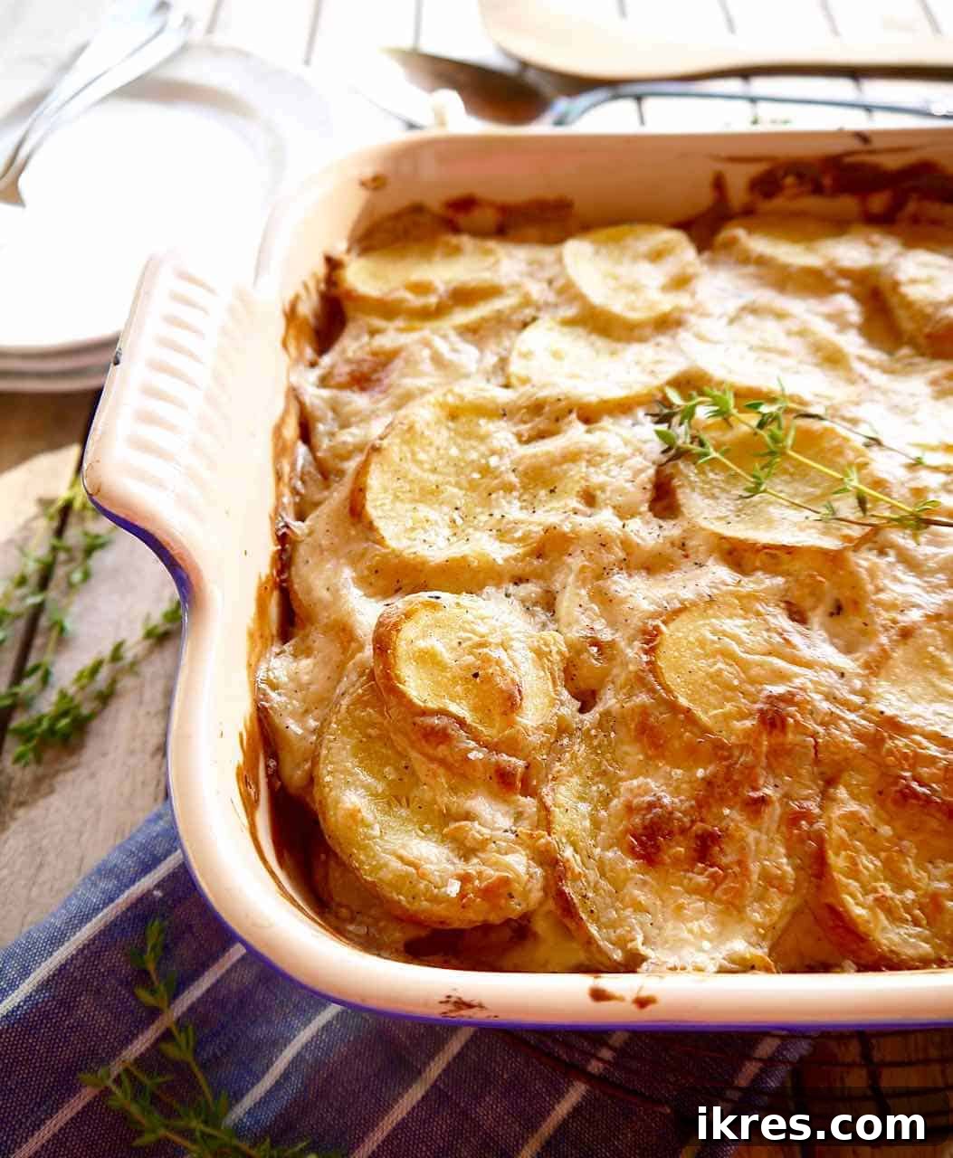 Creamy Dairy Free Scalloped Potatoes Paleo Whole30 Gluten Free 2 Golden brown dairy-free scalloped potatoes gratin, freshly baked and crispy on top, served in a white baking dish.