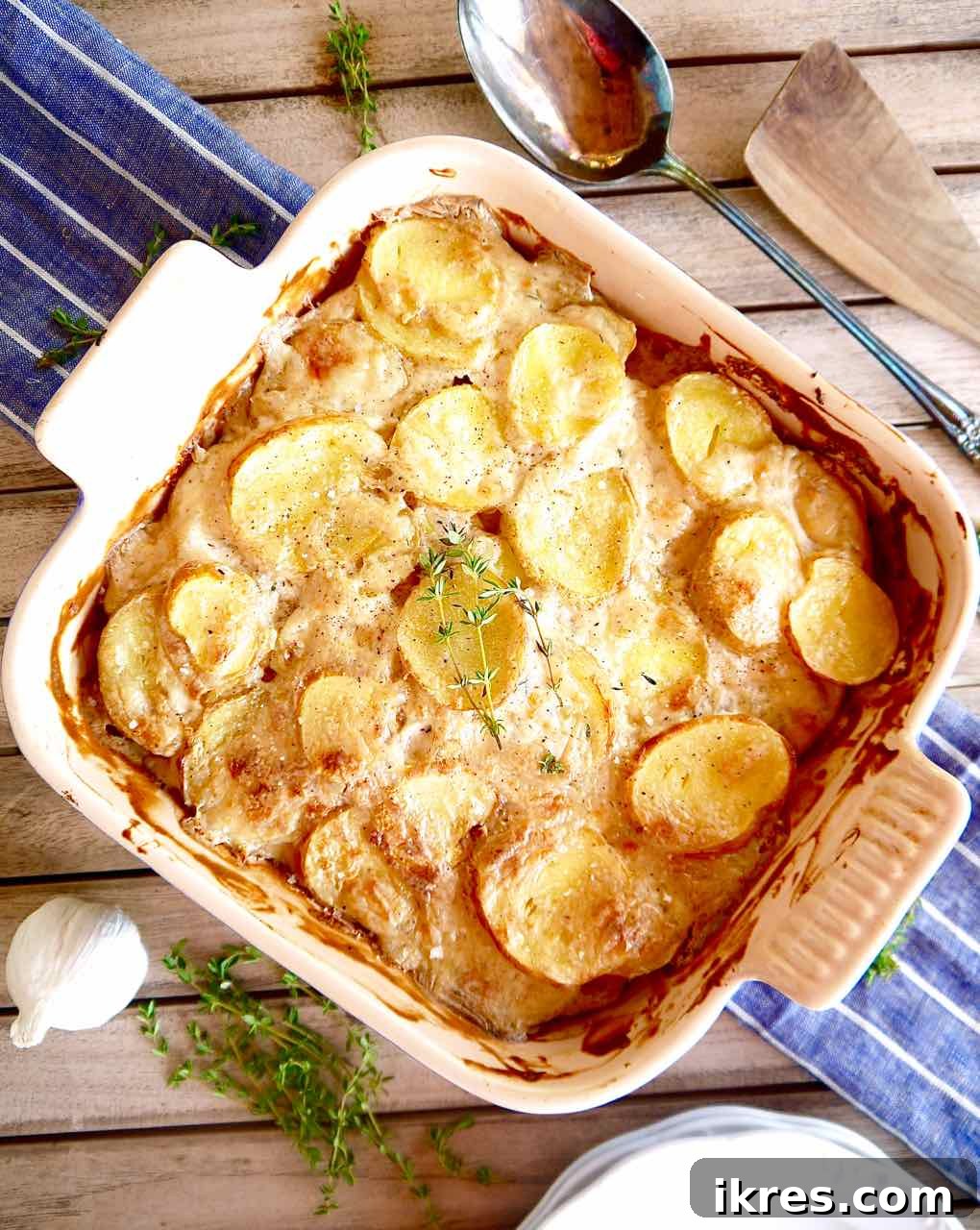 Creamy Dairy Free Scalloped Potatoes Paleo Whole30 Gluten Free 10 Aerial shot of a baking dish filled with golden brown dairy-free scalloped potatoes, ready to be served.