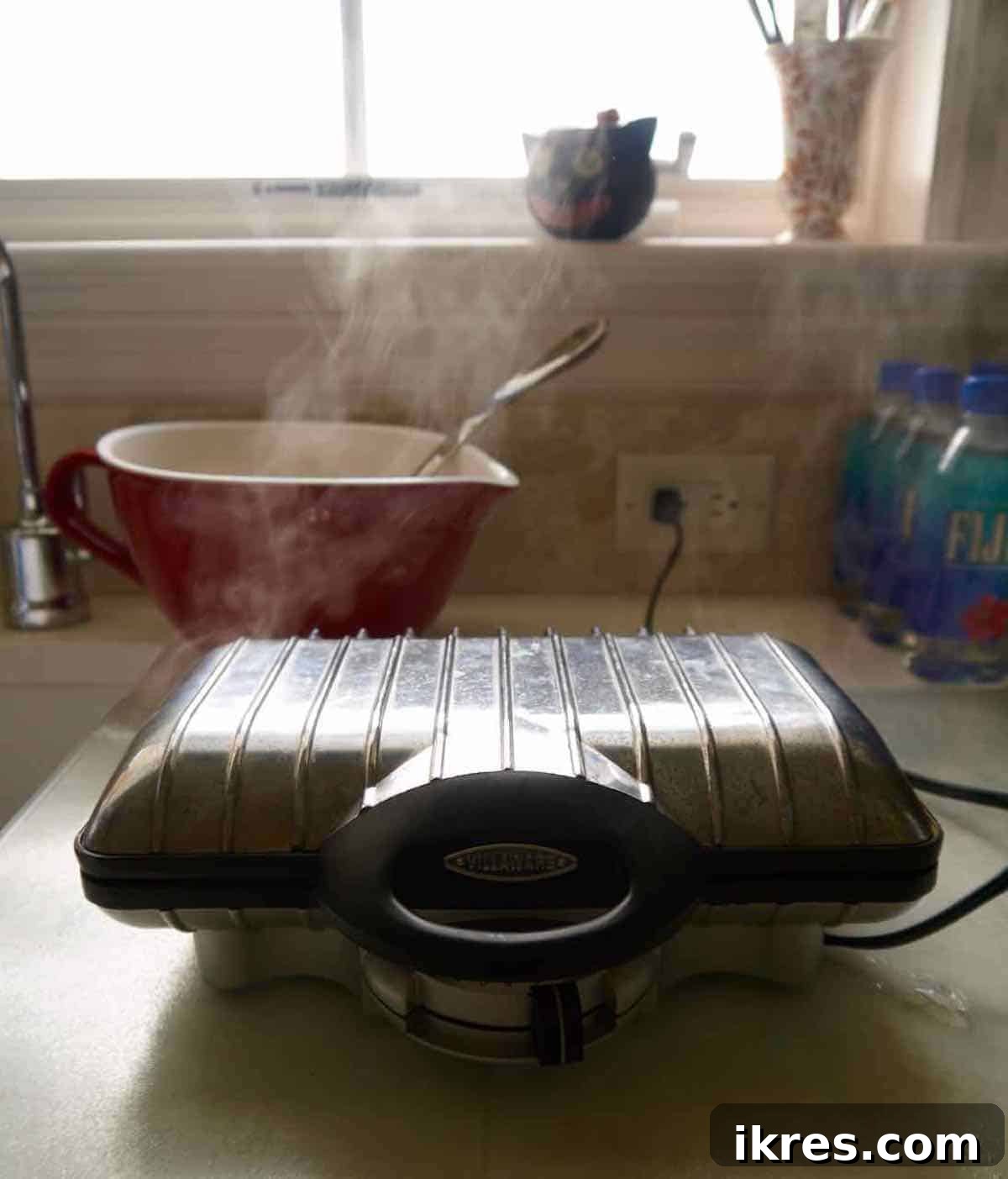 Waffle maker cooking paleo pumpkin waffles.