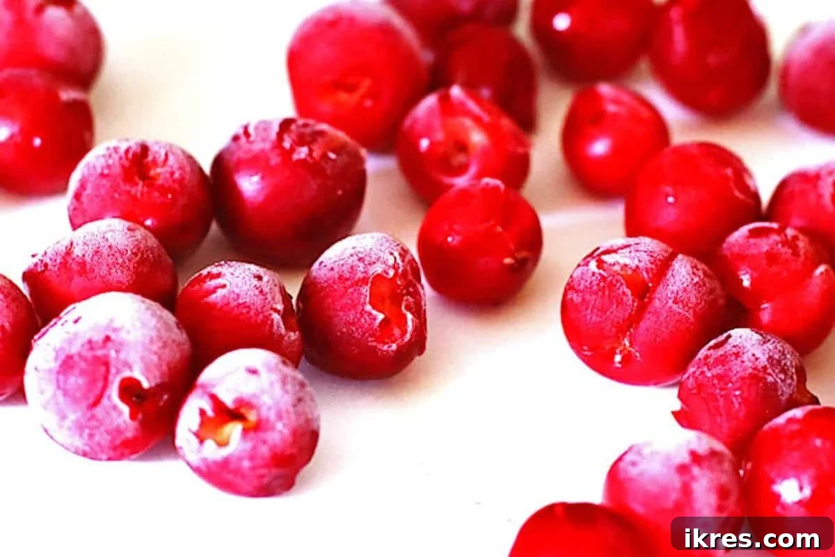 Fresh cherries on a baking sheet, ready for freezing.