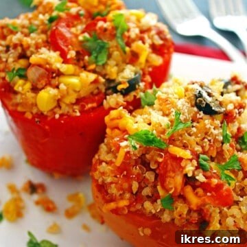 Comforting Crockpot Stuffed Peppers 8 Two red bell peppers generously stuffed with quinoa and vegetables, showcasing a delicious crockpot meal.